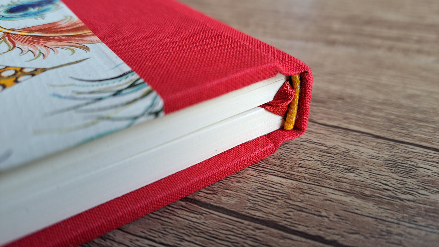 A5 Journal/Notebook (lined) - red cloth bound with peacock design front cover